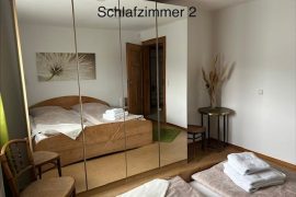 Ein Doppelbett ist in einem Spiegelschrank zu sehen.