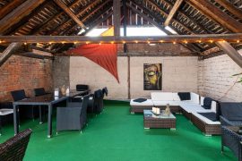 Flair Hotel Hopfengarten in Miltenberg - halboffene Lounge mit Terrassenmöbeln im Obergeschoss der Scheune